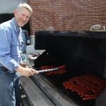 Public Service Recognition Week 2016: man BBQing hotdogs