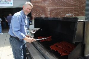 Public Service Recognition Week 2016: man BBQing hotdogs